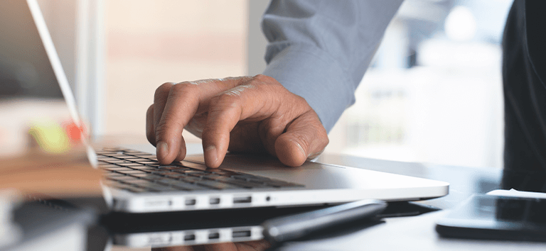 Pessoa com computador, trabalhando em estratégias de marketing para advogados.